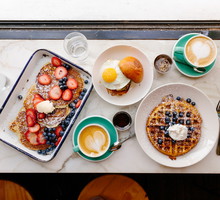 Directly above view of a brunch with pancakes, waffle and burger with fried egg in a restaurant