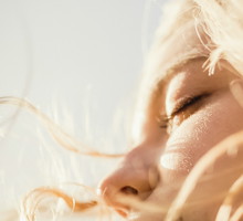 Close up serene woman enjoying wind and sunshine