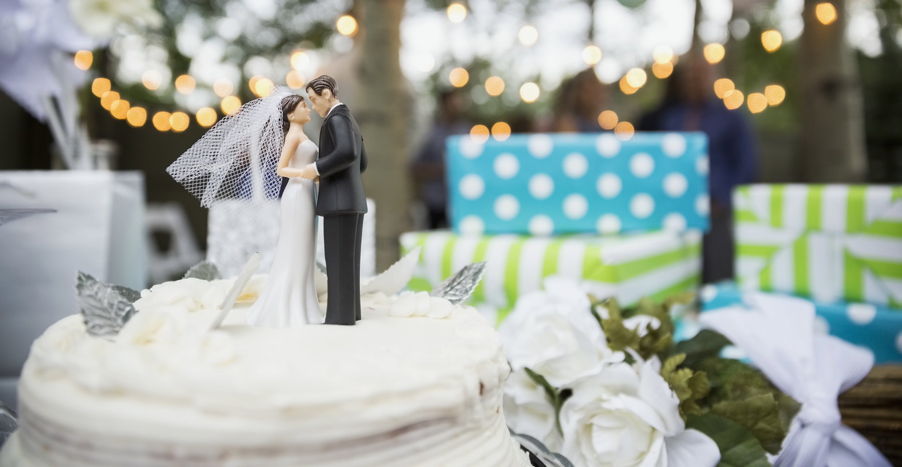 Bride and groom cake topper on cake