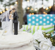 Bride and groom cake topper on cake