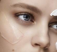 close up of a young woman with cream and gel on her face
