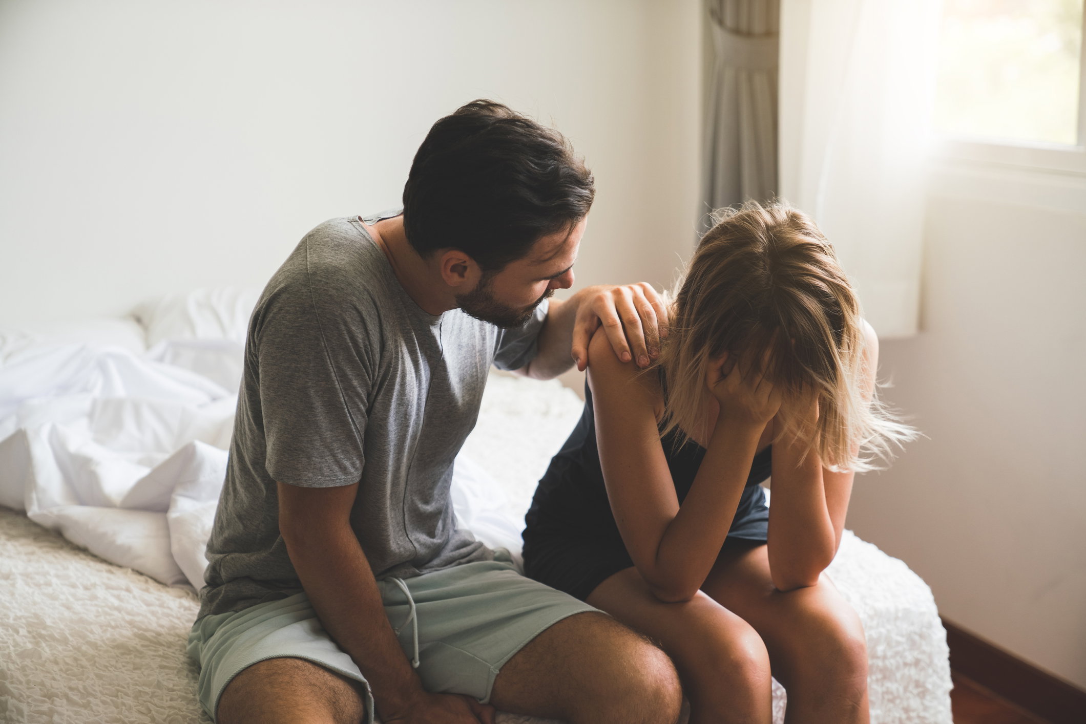 Loving husband comfort upset offended wife, caressing and hugging