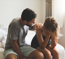 Loving husband comfort upset offended wife, caressing and hugging