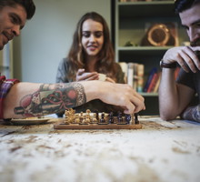 Young tattooed males playing chess