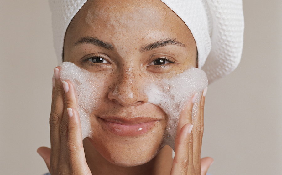 Young woman washing face