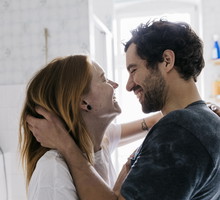 Couple Affectionately Embracing And Smiling Together