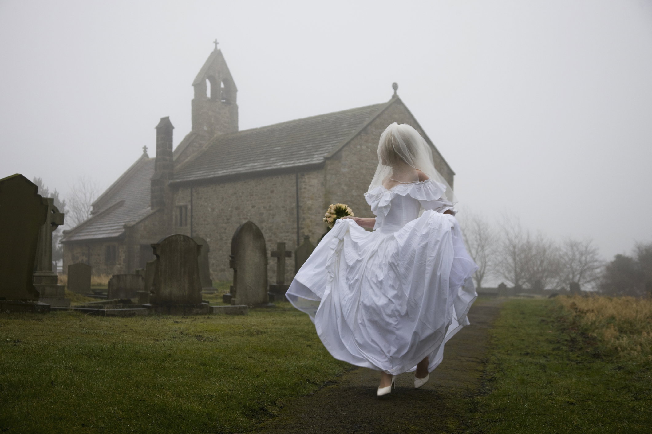 bride running away from a church