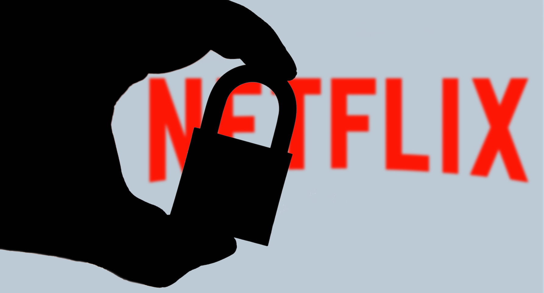In this photo illustration a hand seen holding a padlock and