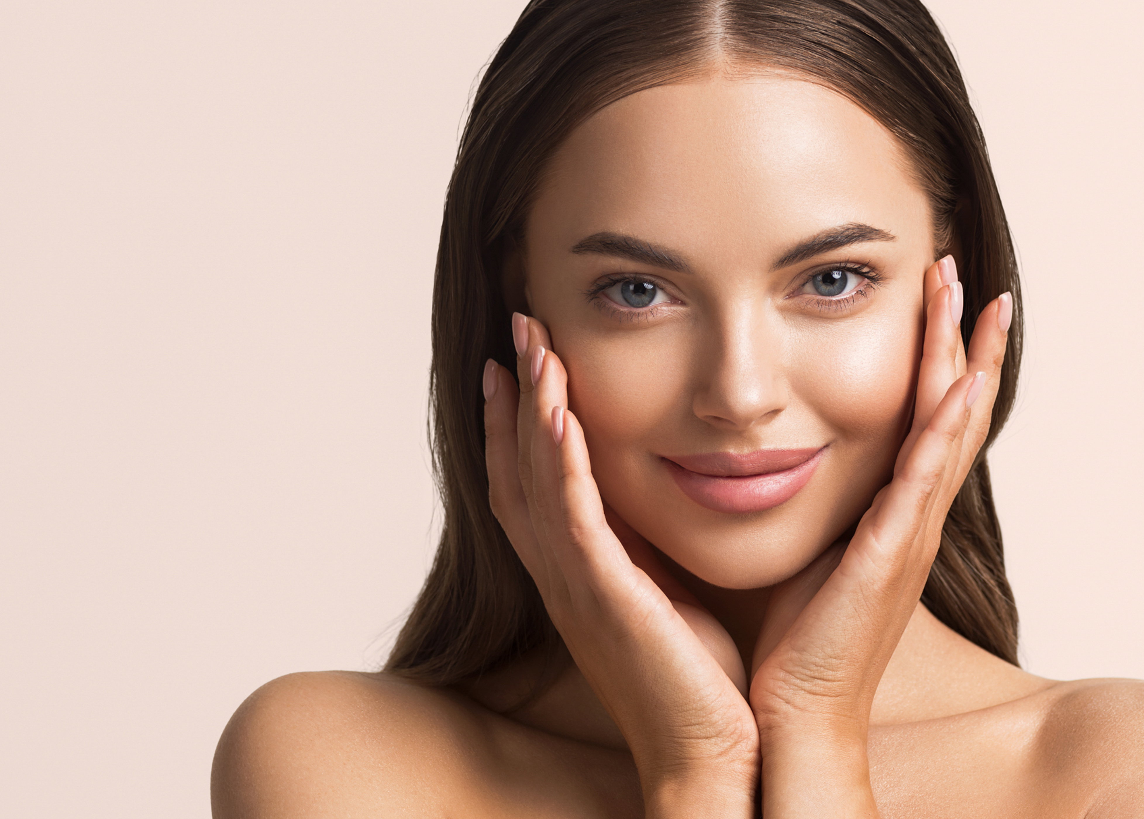 Beautiful woman face close up natural make up hand touching face