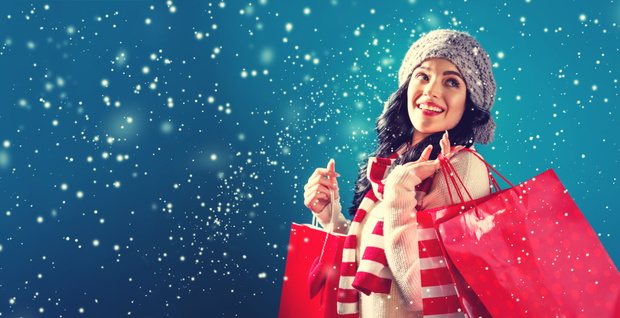 Happy young woman holding shopping bags