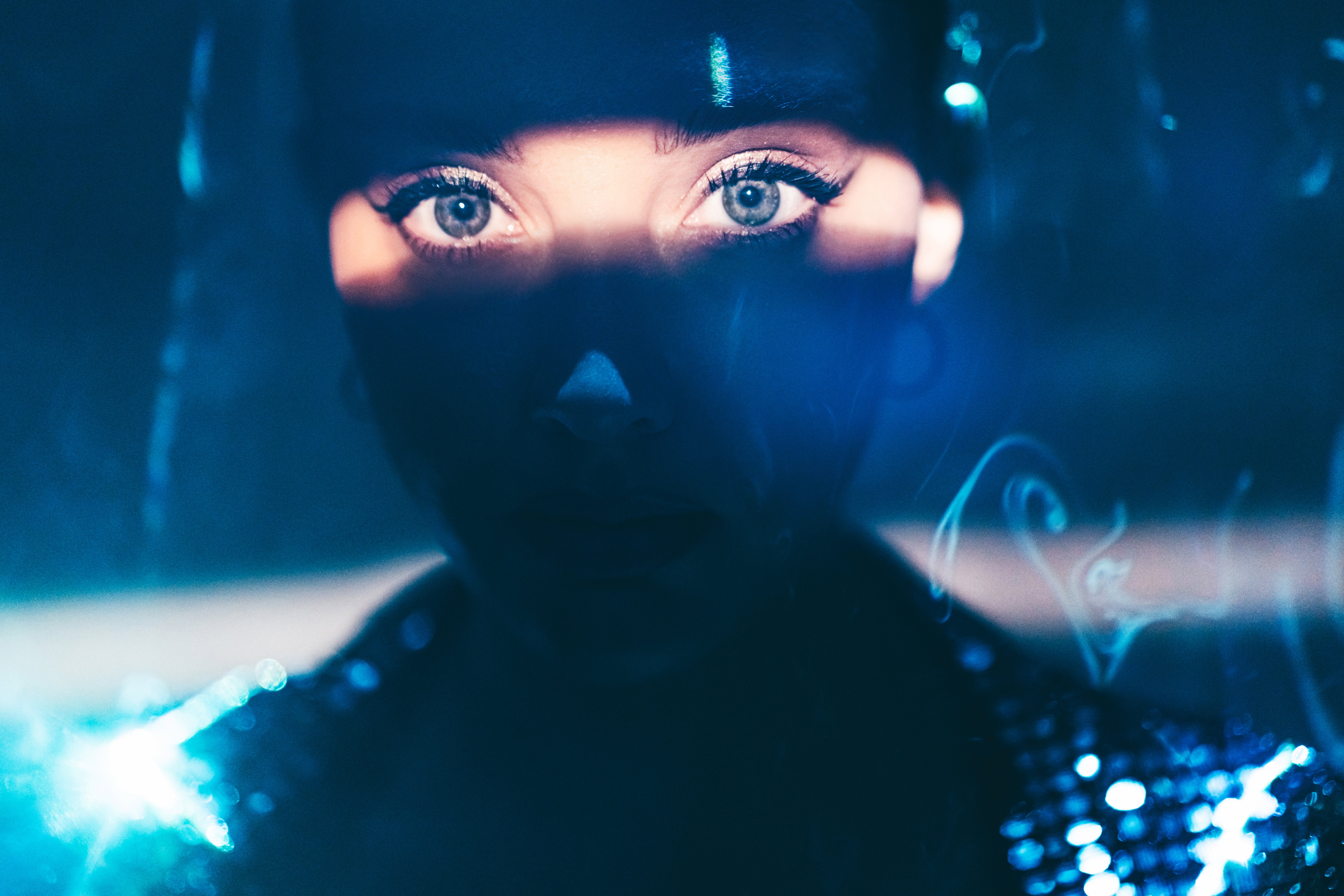 Portrait of beautiful woman lit by neon colored lights.