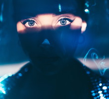 Portrait of beautiful woman lit by neon colored lights.