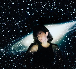 Image projection of space on a young beautiful woman with short curly hair.