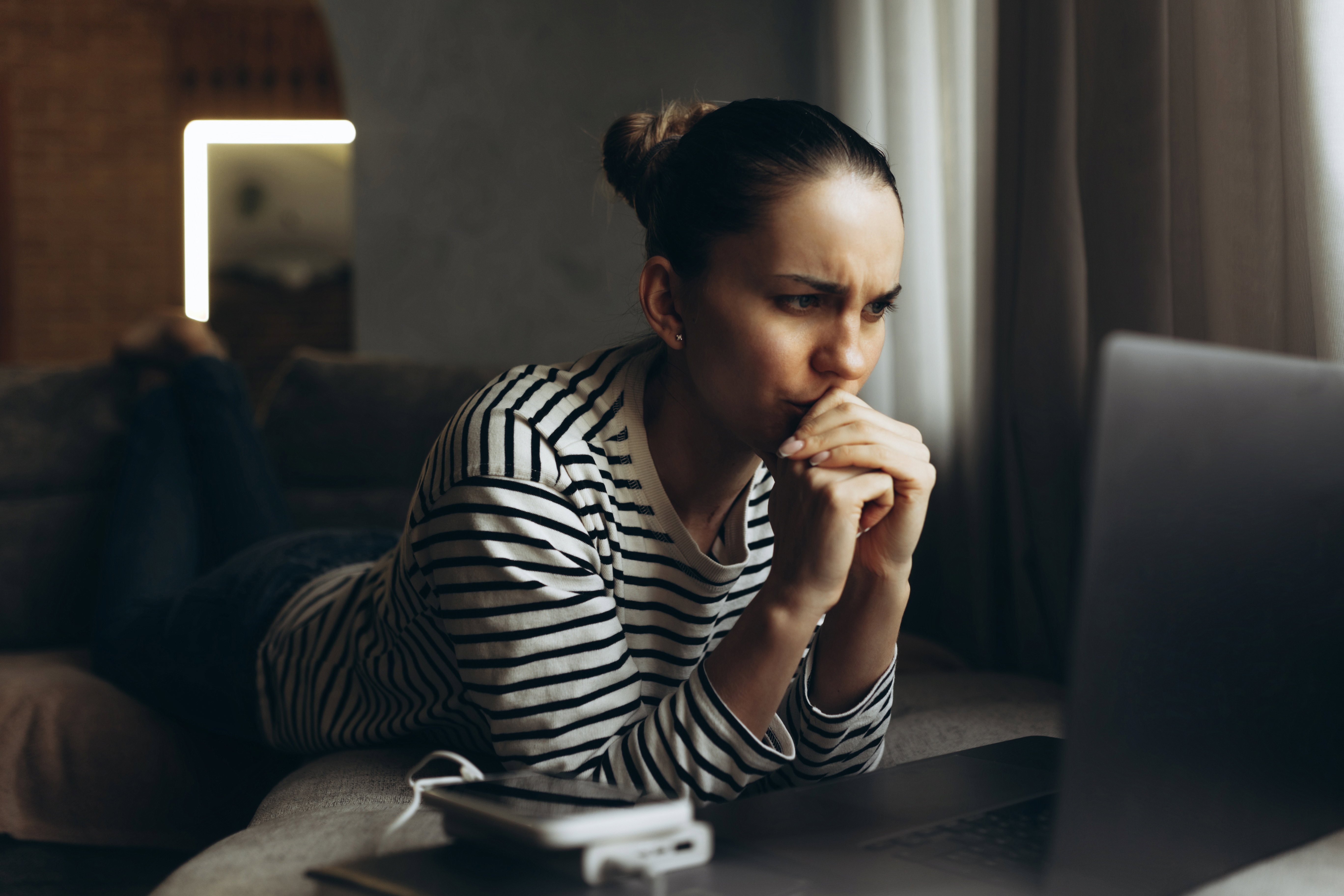 Stressed businesswoman working on laptop at home, tired freelancer