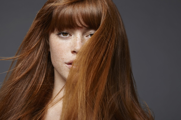 Studio portrait of young woman with long brown hair