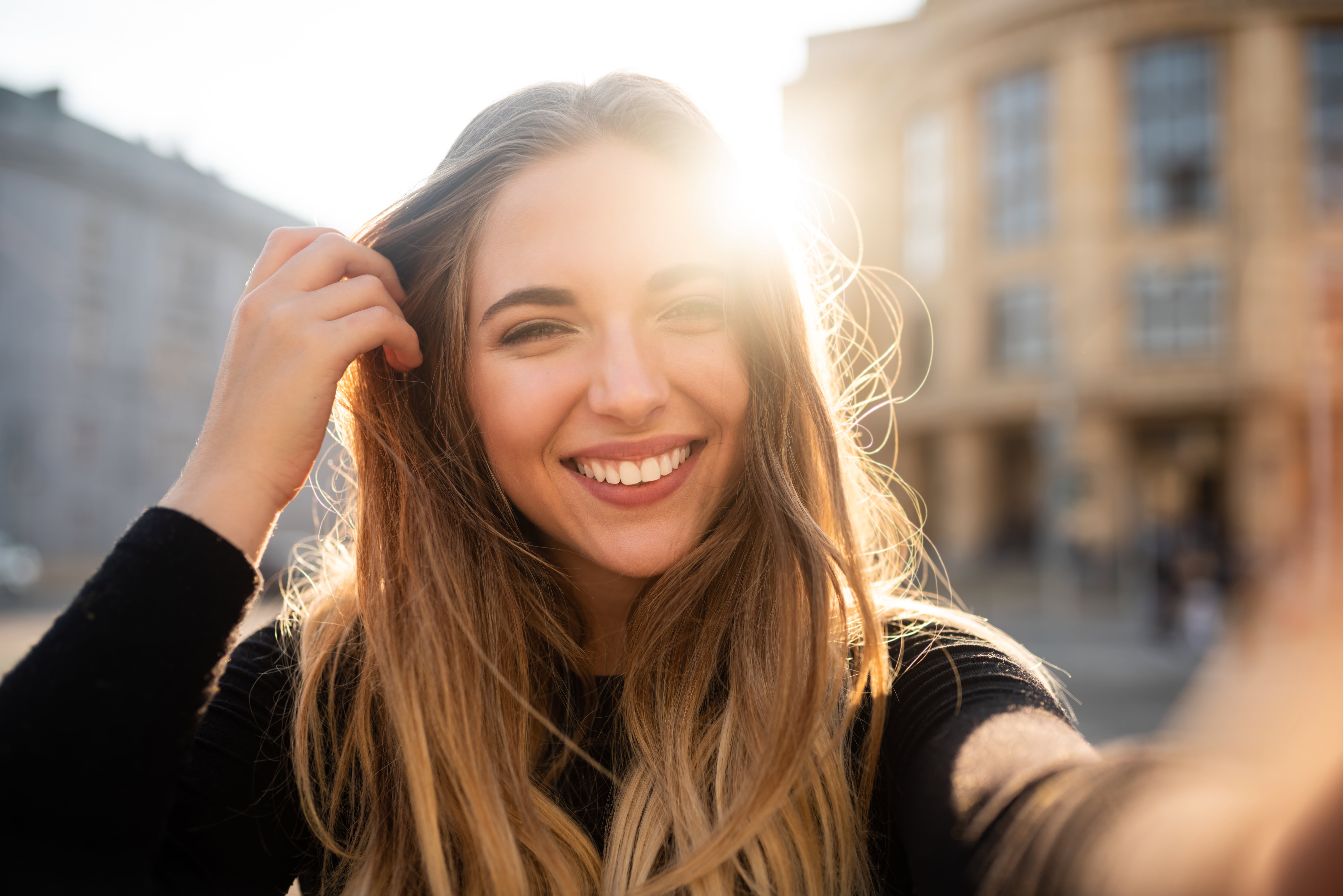 Self portrait of playful smiling young woman