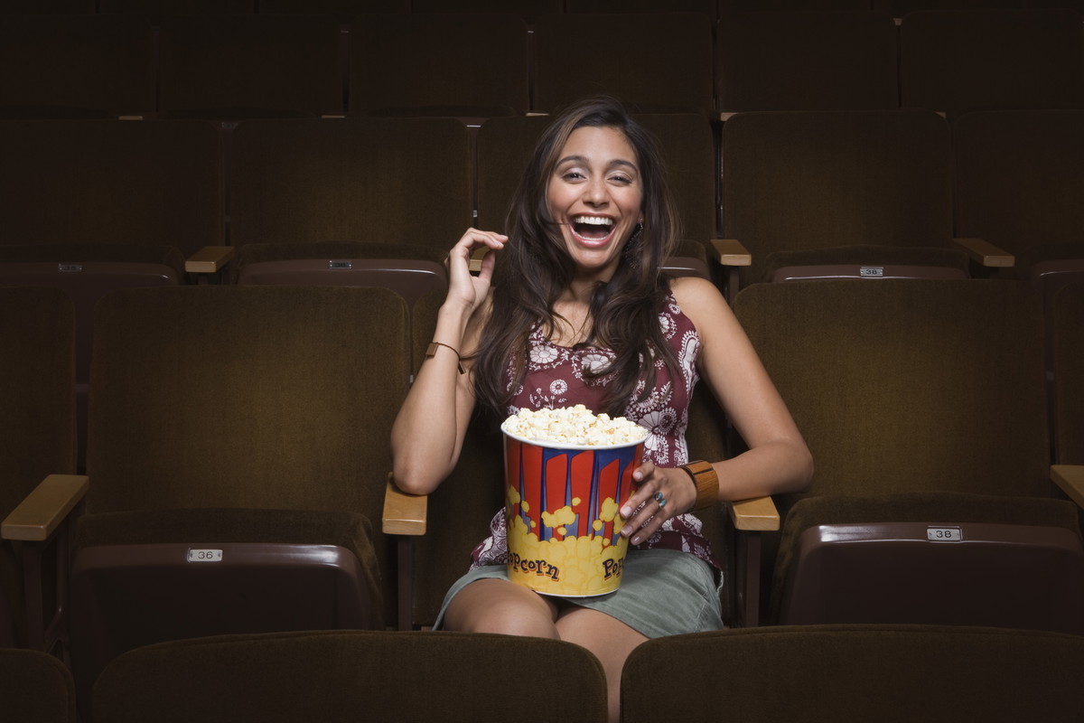Woman laughing in movie theatre