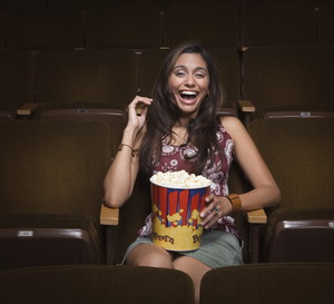 Woman laughing in movie theatre
