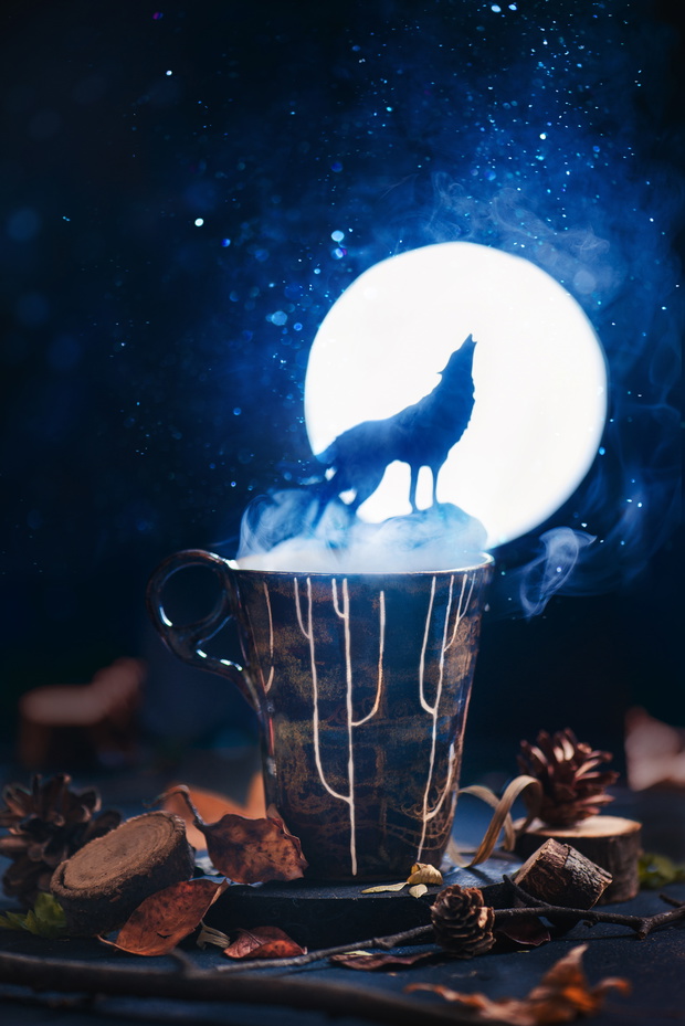 Howling on Moon wolf silhouette on a ceramic mug in a forest scene. Nature concept, magical food photography.
