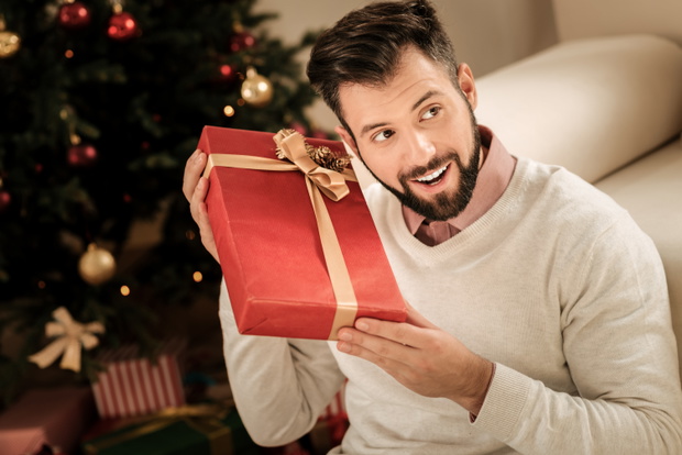Cheerful happy man being excited about the present
