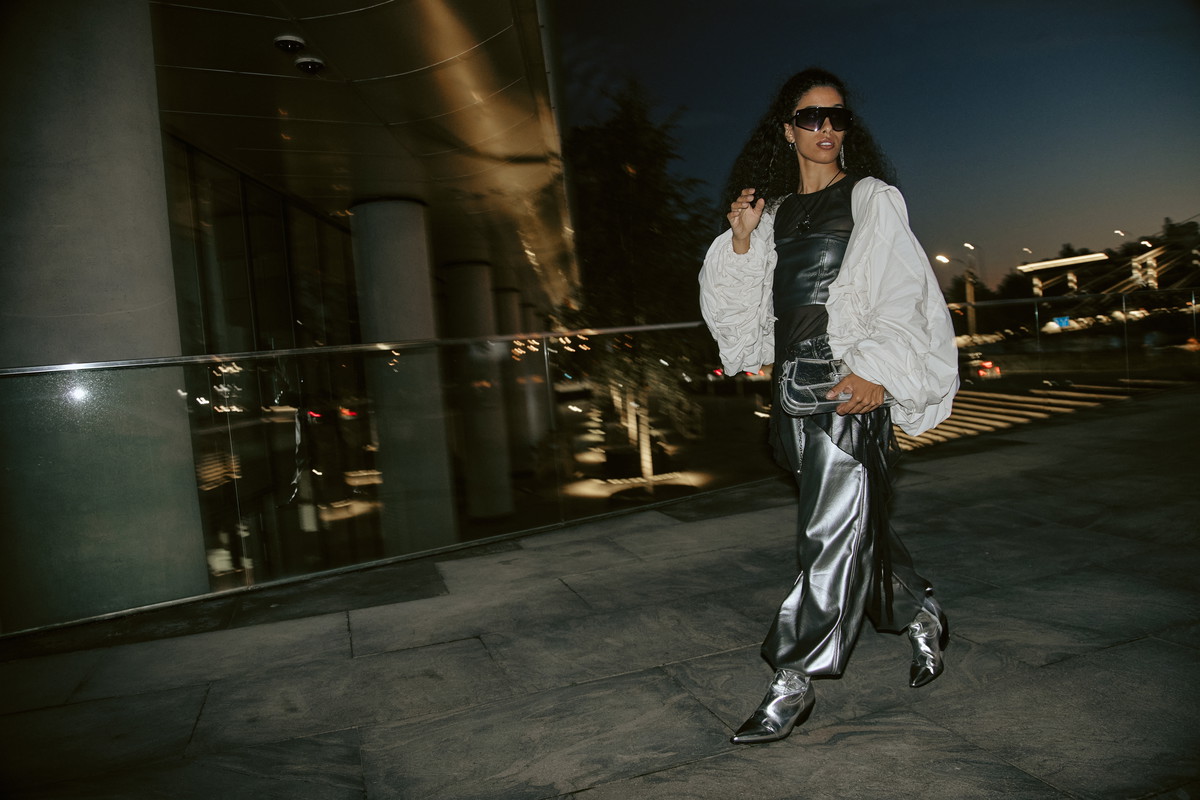 Female Model in Silver Pants Walking in Night City Street