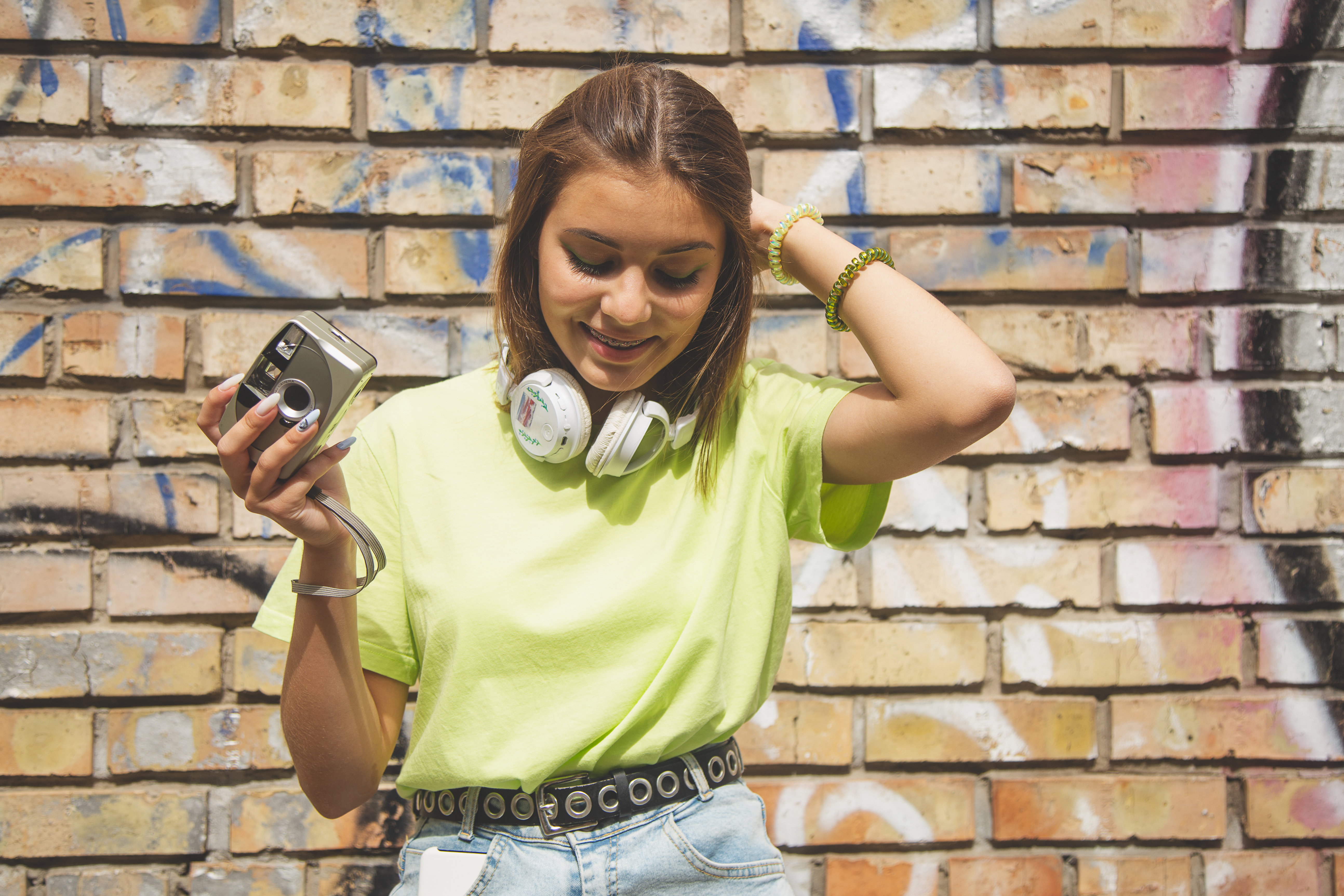 Life style portrait of beautiful modern girl with film camera