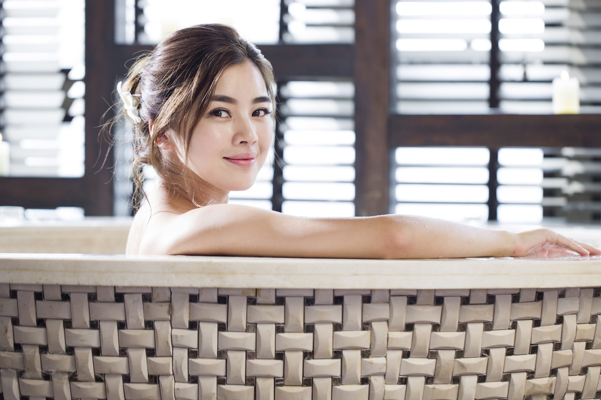 Beautiful young woman in bathtub