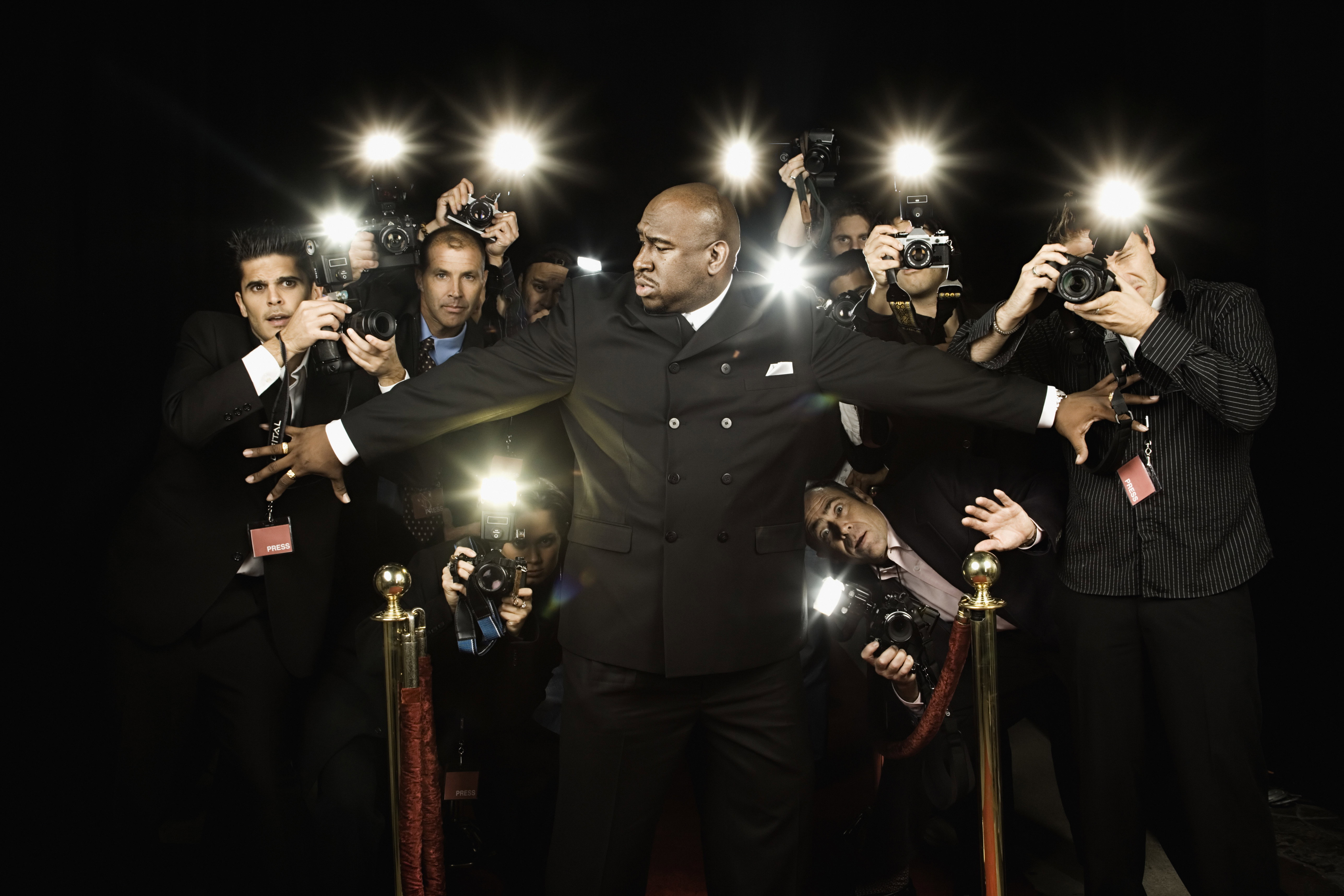 Bouncer holding photographers back