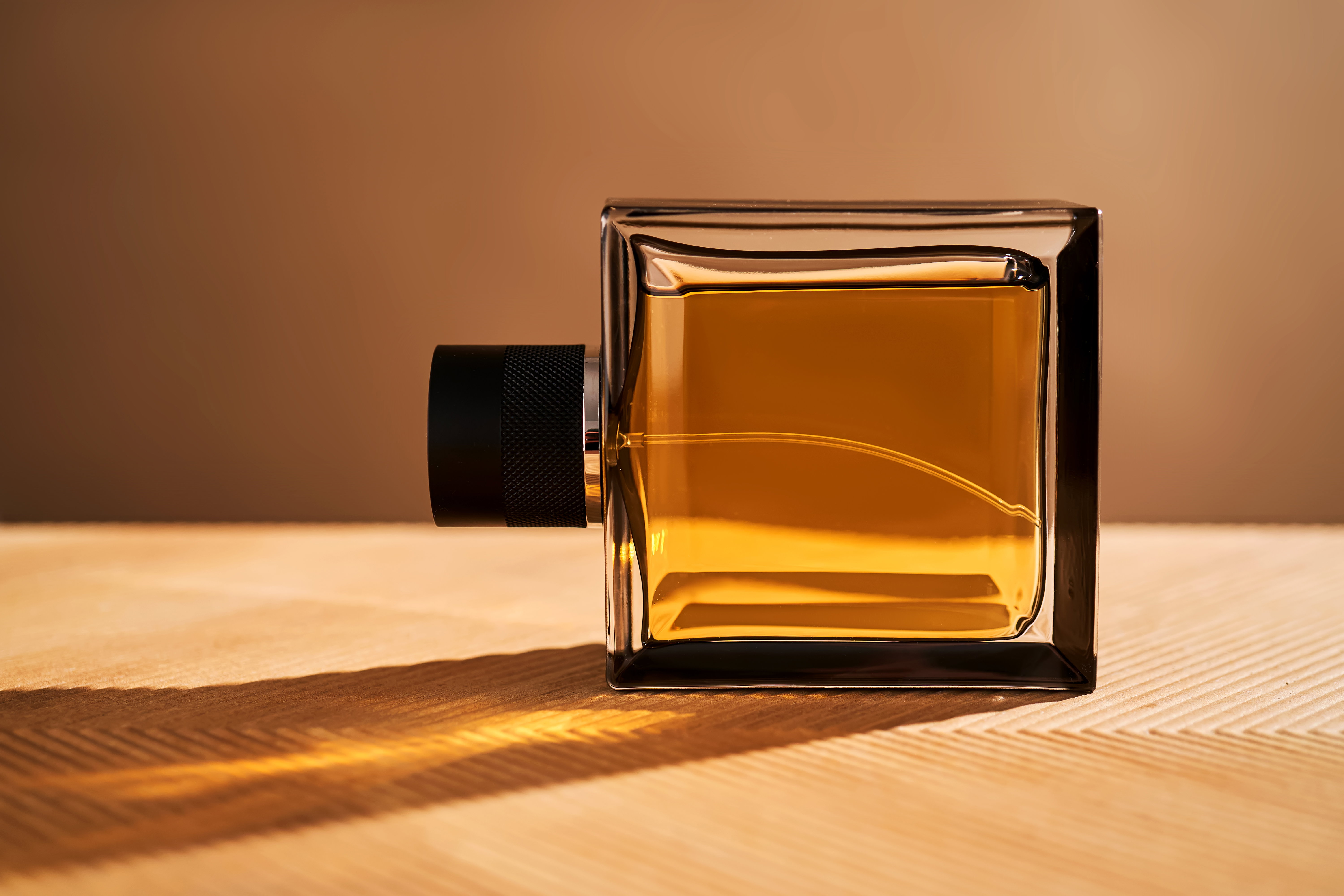 Perfume bottle in the bright rays of the sun.