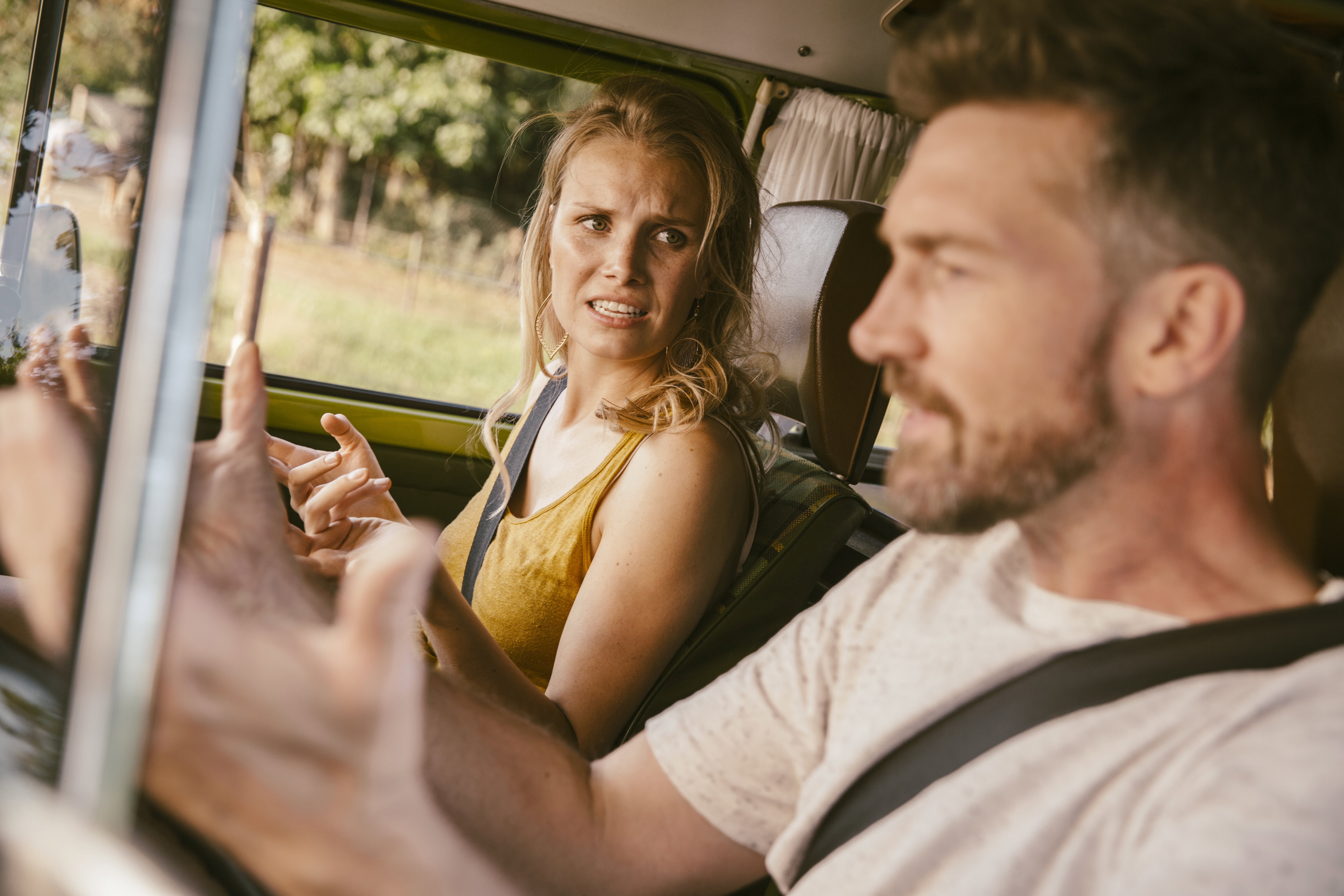 Couple arguing in van on a road trip