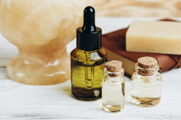 Jade mortar and pestle, hemp soap on book and cbd oil in flacons