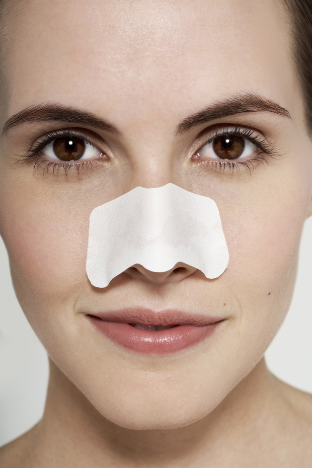 Female with beauty pads on face