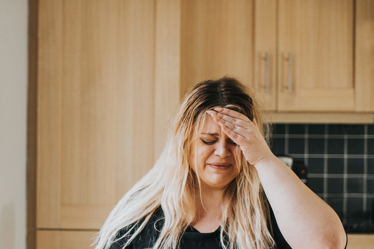 Distressed Woman at a kitchen table talking to her partner