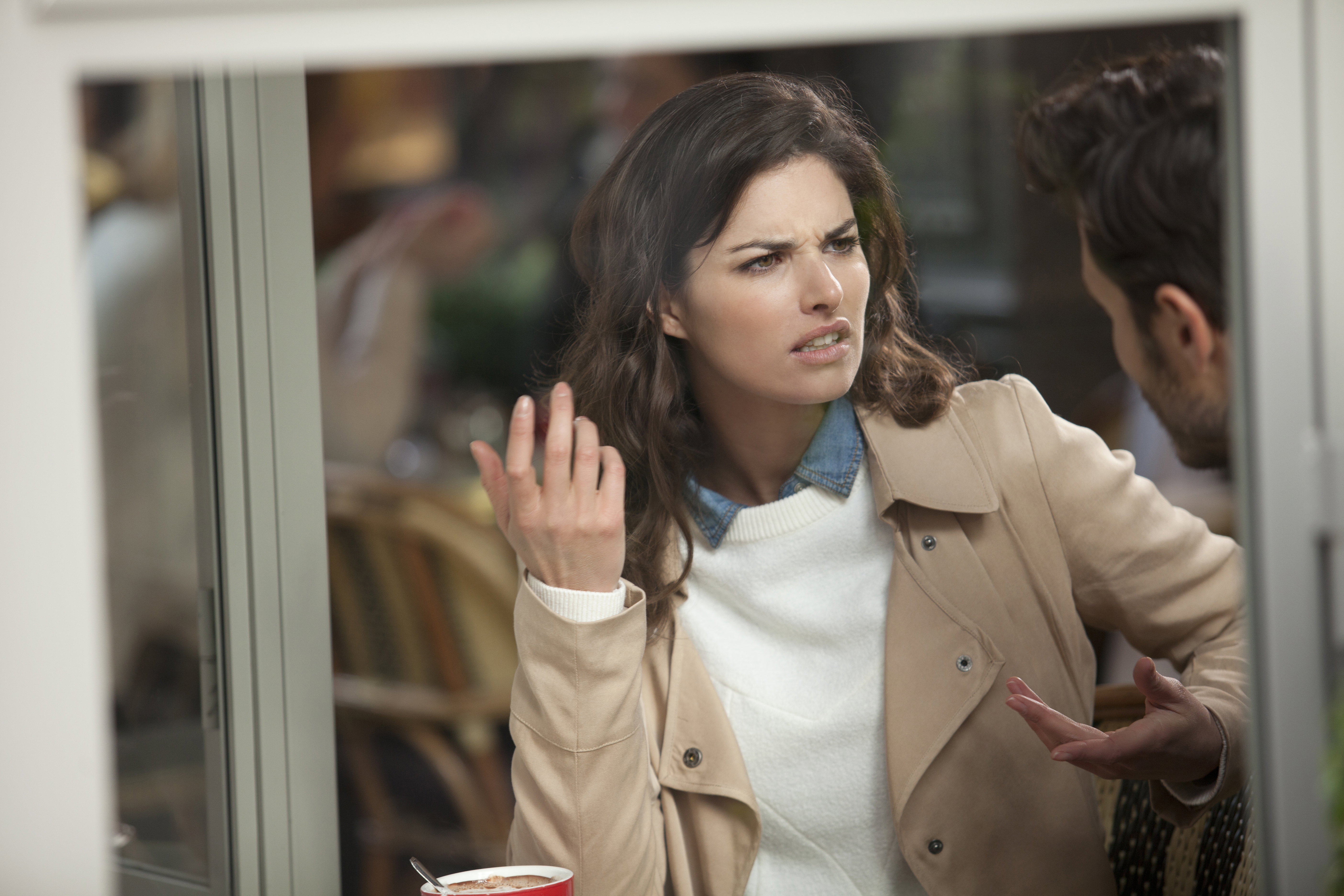 Couple arguing in a cafe