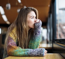 depressed girl looking out the window