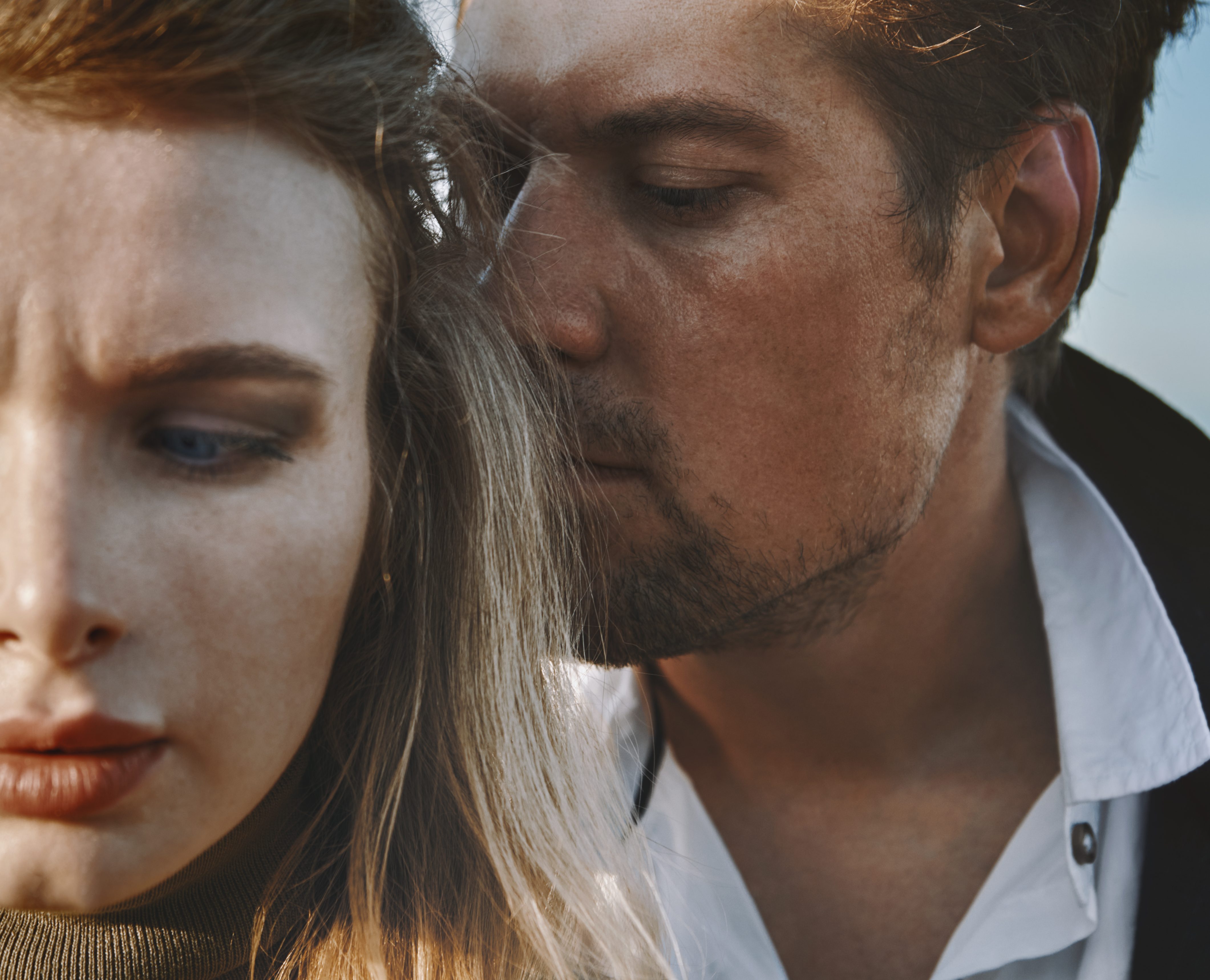 Worried and introspective couple against the sky