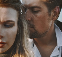 Worried and introspective couple against the sky