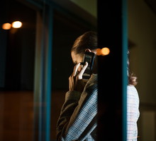 Businesswoman using mobile phone in office at night