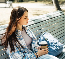 Portrait of teenage girl sitting on the bench in the park