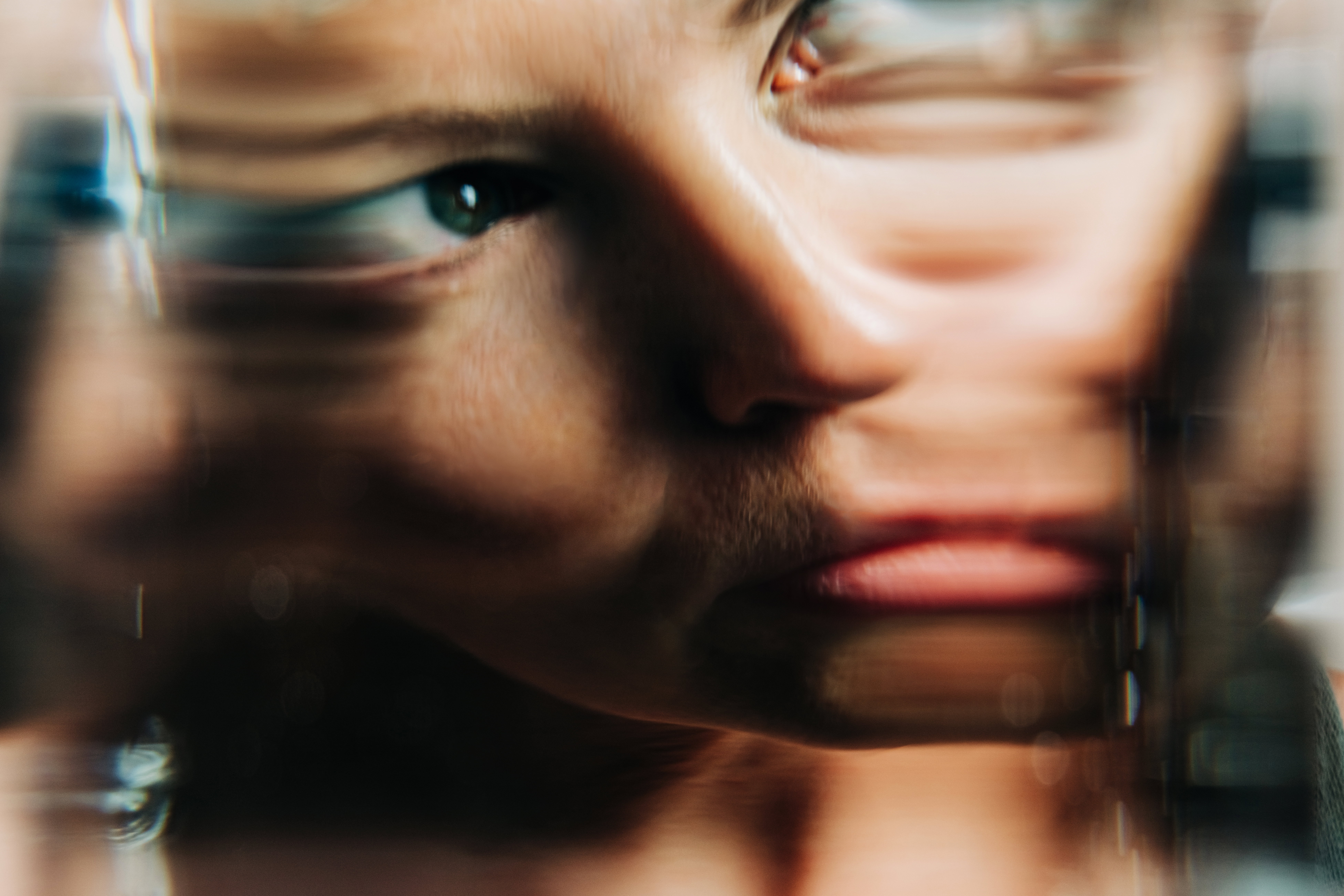 Portrait of female through glass of water.