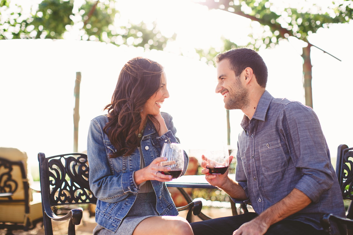 Couple enjoy glasses of wine at outdoor bar
