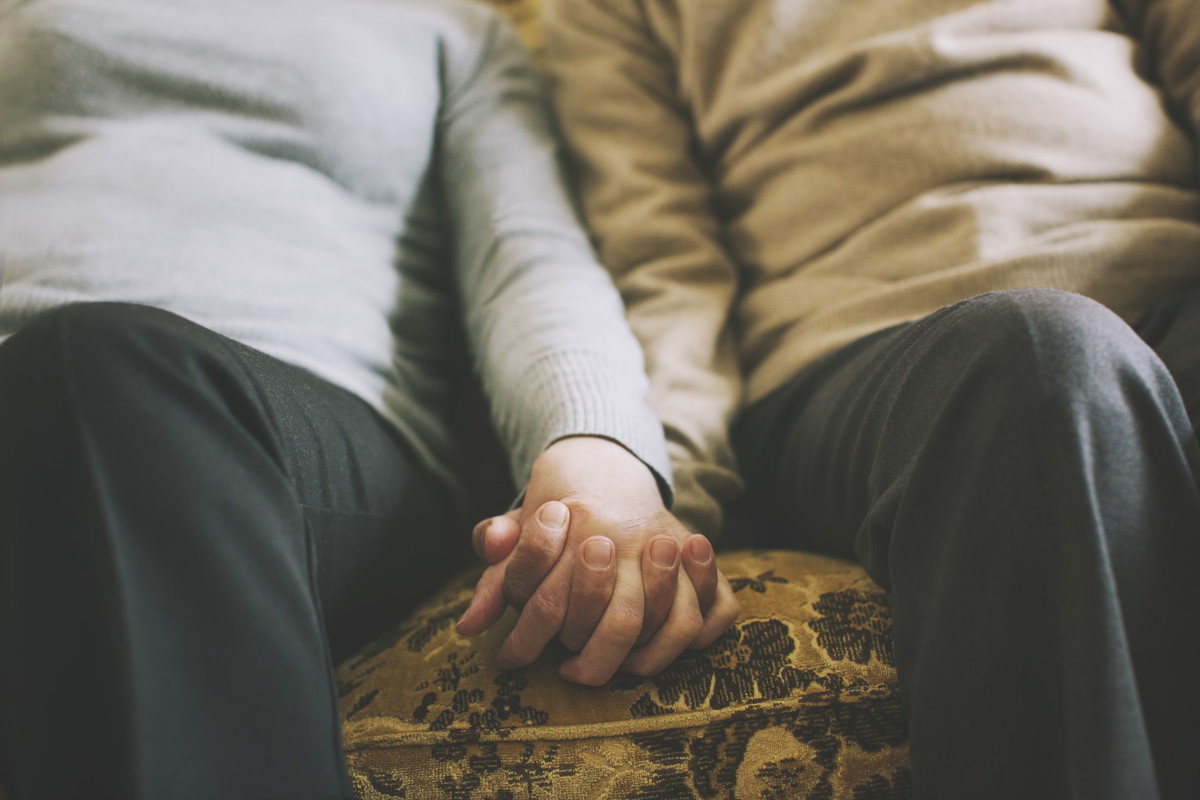 Senior couple holding hands