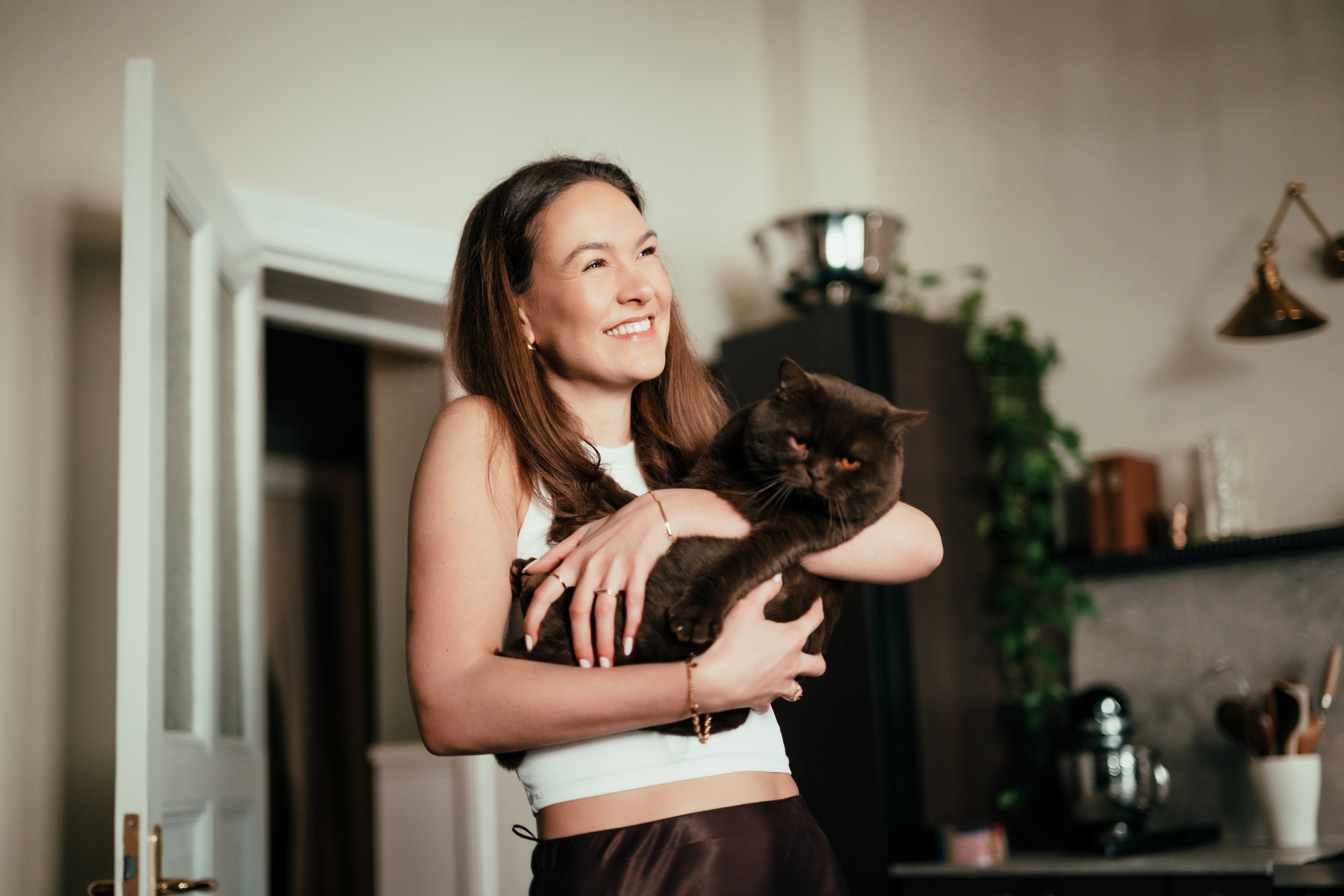 Young woman holding her pet cat