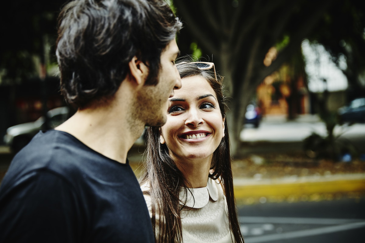Smiling woman in discussion with boyfriend