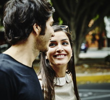 Smiling woman in discussion with boyfriend