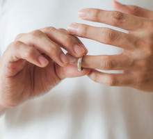 A young man is removing his wedding ring a concept of relationship difficulties