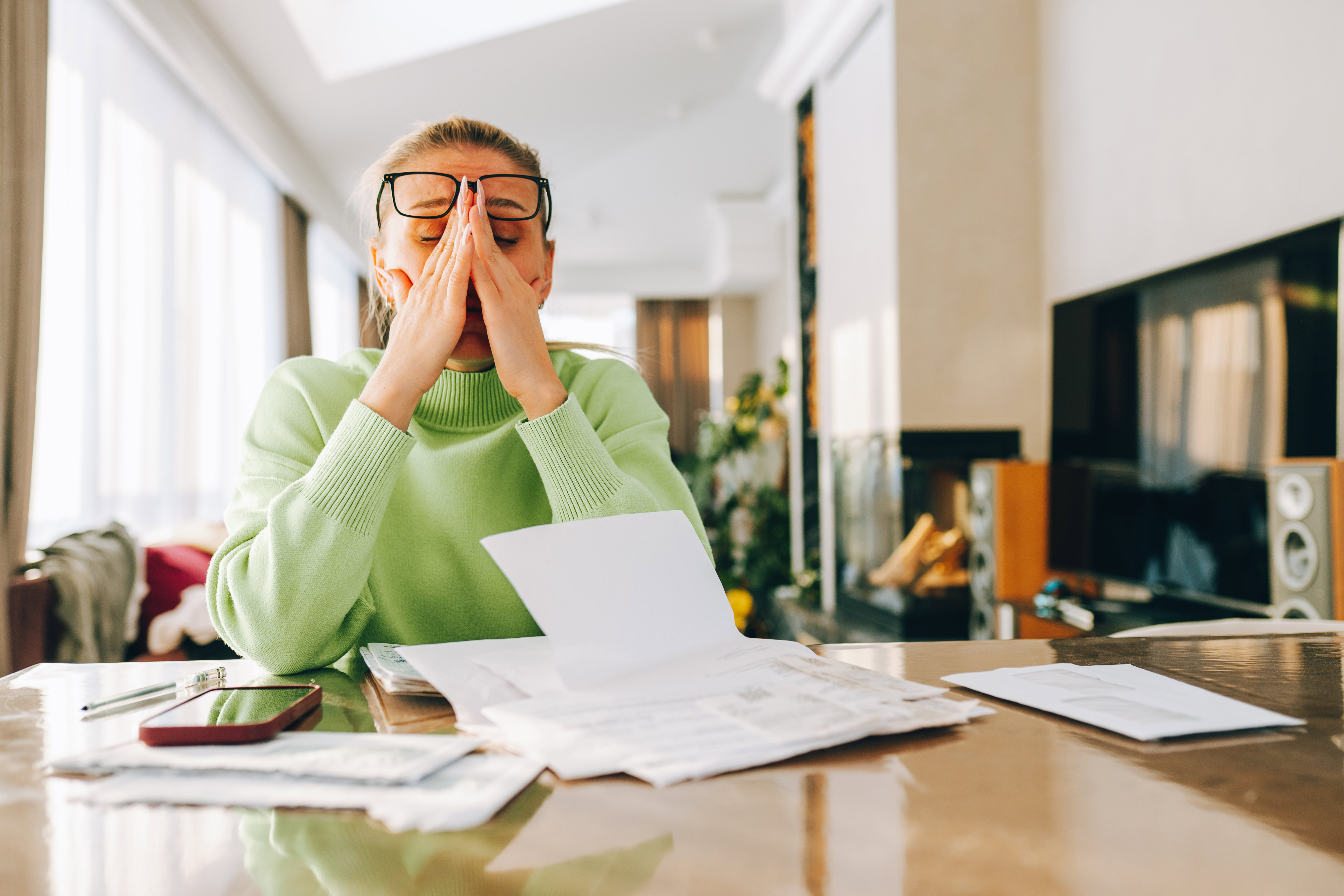 Stressed woman experiencing financial problems and debt at home