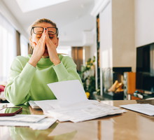 Stressed woman experiencing financial problems and debt at home