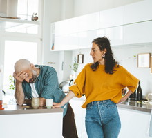 Serious woman arguing with man in kitchen at home