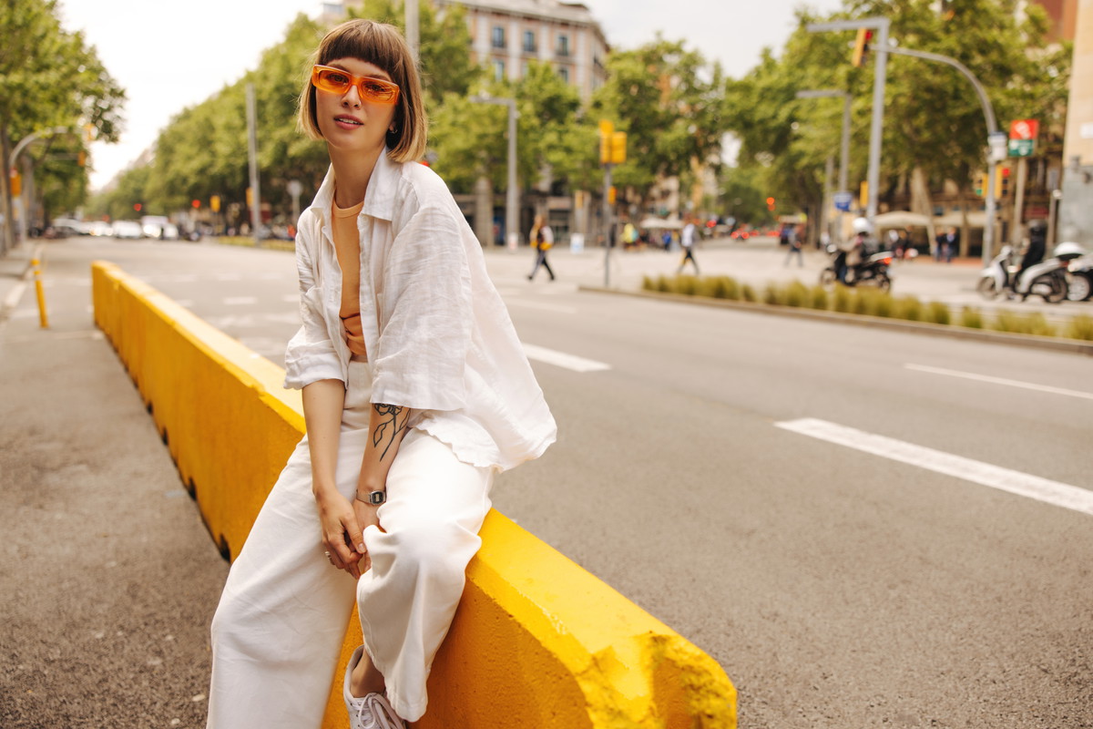 Modern young caucasian girl posing looking at camera outdoors.